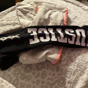 Black justice leggings and grey sweatpants with rainbow colors down the side